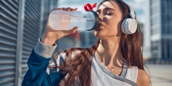 lady drinking bottle of water