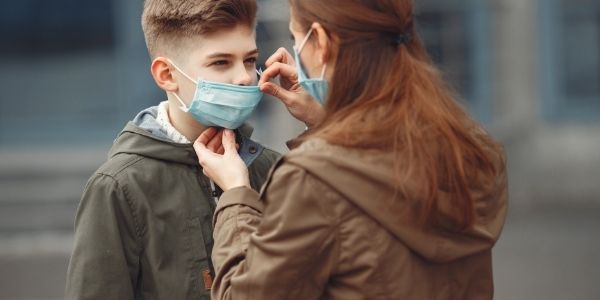 mom putting a mask on her son